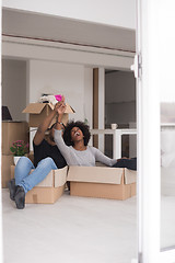 Image showing African American couple  playing with packing material