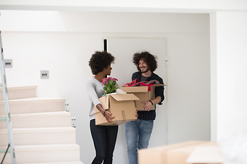 Image showing multiethnic couple moving into a new home