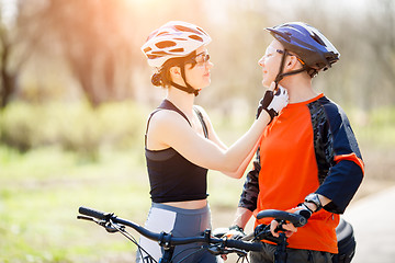 Image showing Two friends wear bike helmets