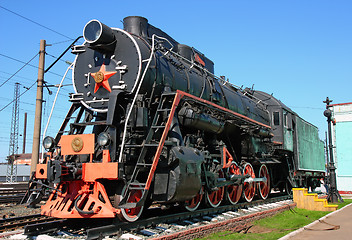 Image showing Old black locomotive in the railway depot in the parking lot