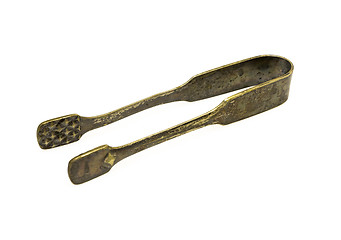 Image showing Old silver sugar tongs and ice on a white background