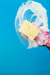 Image showing Cleaning glass window with sponge