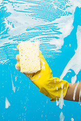 Image showing Man washes window with sponge