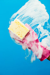 Image showing Washing window with soap and sponge