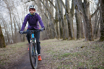 Image showing Girl in helmet riding bicycle
