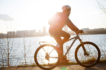 Image showing Woman in helmet on bicycle