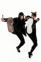 Image showing The silhouettes of two hip hop male and female break dancers dancing on white background