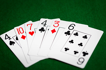 Image showing poker hand of playing cards on green casino cloth