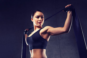 Image showing woman with expander exercising in gym