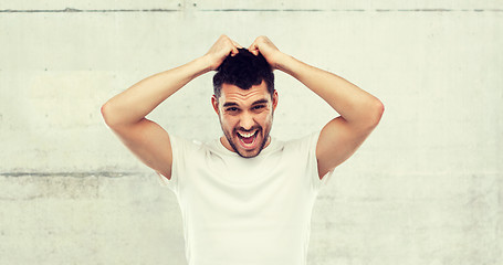 Image showing crazy shouting man in t-shirt over gray background