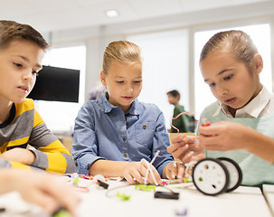 Image showing happy children building robots at robotics school