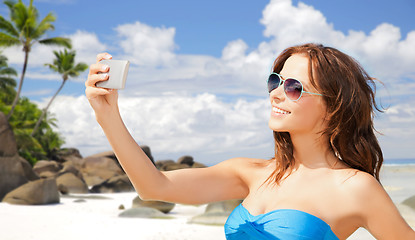 Image showing woman in swimsuit taking selfie with smatphone