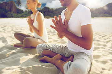 Image showing close up of couple making yoga exercises outdoors