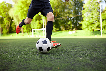 Image showing soccer player playing with ball on field