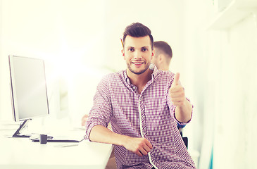 Image showing happy creative man with computer at office