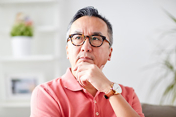 Image showing asian man thinking at home