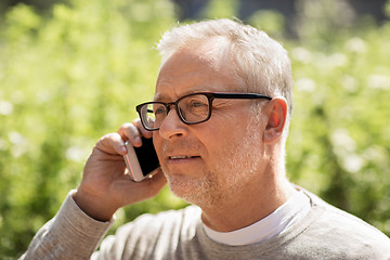 Image showing happy senior man calling on smartphone in city