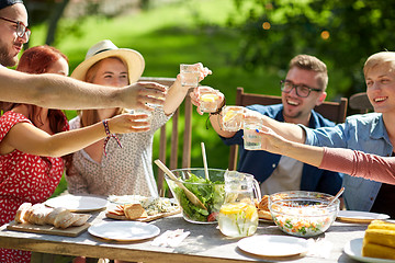 Image showing happy friends with drinks at summer garden party