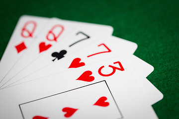 Image showing poker hand of playing cards on green casino cloth