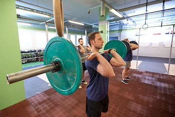 Image showing group of men training with barbells in gym