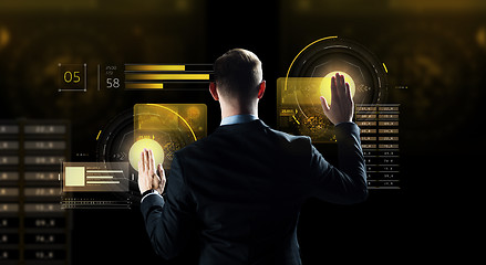 Image showing businessman touching virtual screen