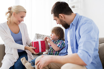 Image showing happy family with birthday gift at home