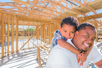 Image showing Young African American Father and Mixed Race Son On Site Inside 