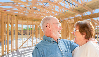 Image showing Senior Couple On Site Inside Their New Home Construction Framing