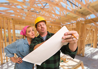 Image showing Contractor Showing Plans to Woman On Site Inside New Home Constr