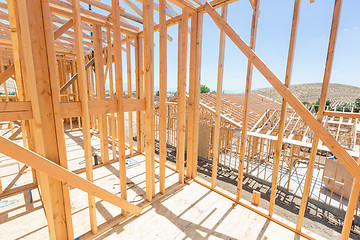 Image showing Wood Home Framing Abstract At Construction Site.