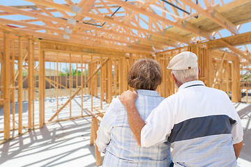 Image showing Senior Couple On Site Inside Their New Home Construction Framing