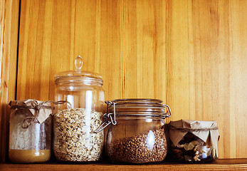 Image showing real comfort wooden kitchen with breakfast ingredients close up 