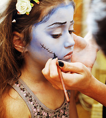 Image showing little cute child making facepaint on birthday party, zombie Apo