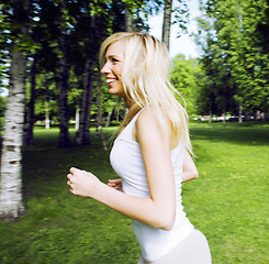 Image showing blonde real girl doing yoga in green park, lifestyle sport peopl