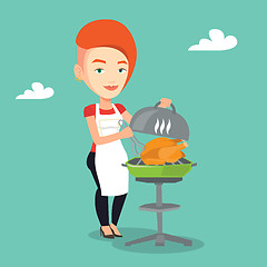 Image showing Woman cooking chicken on barbecue grill.