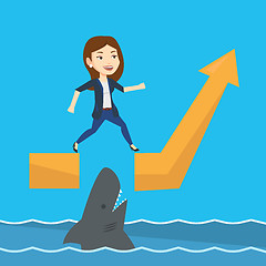 Image showing Business woman jumping over ocean with shark.