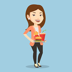 Image showing Woman holding tray full of fast food.