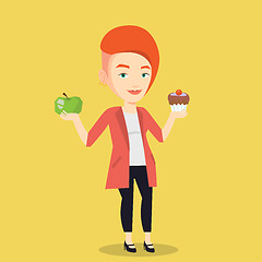 Image showing Woman choosing between apple and cupcake.