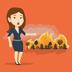 Image showing Woman standing on background of wildfire.