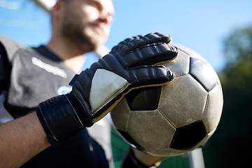 Image showing close up of goalkeeper with ball playing football