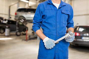 Image showing auto mechanic or smith with wrench at car workshop