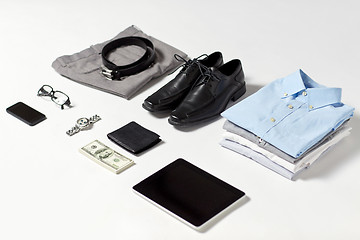 Image showing clothes, gadgets and business stuff on table