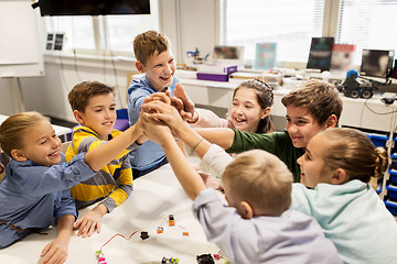 Image showing happy children making high five at robotics school