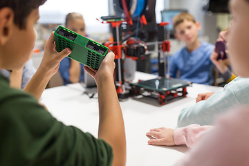 Image showing kids with 3d printer part at robotics school