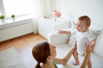 Image showing happy young mother with little baby at home