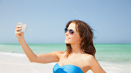 Image showing woman in swimsuit taking selfie with smatphone