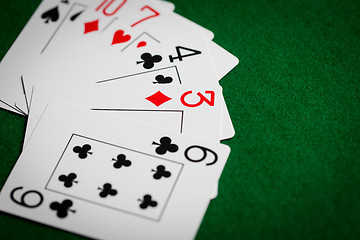 Image showing poker hand of playing cards on green casino cloth