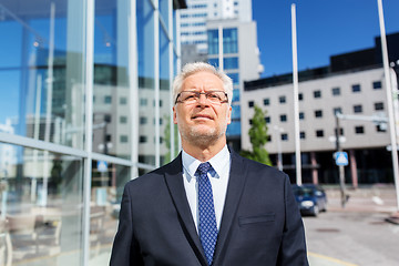 Image showing senior businessman on city street