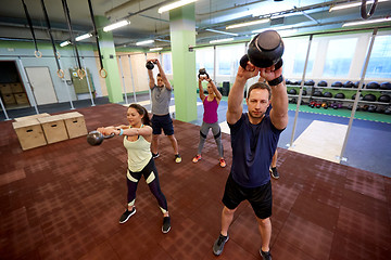 Image showing group of people with kettlebells exercising in gym