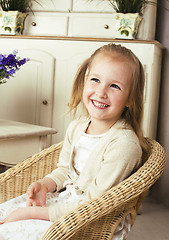 Image showing little cute blonde european girl playing at home interior, lifes